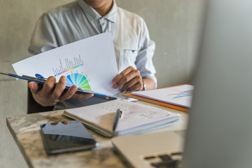 Office man reading financial data on report