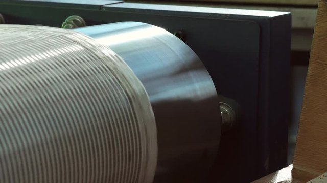 Close-up Of An Industrial Dryer Conveyor Is Spinning In A Print Shop
