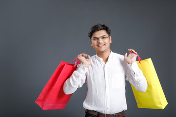 Young Indian man with shopping bags