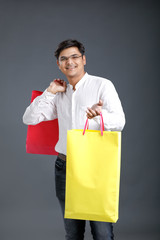 Young Indian man with shopping bags