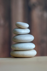 Harmony and balance, cairns, simple poise stones on white background, rock zen sculpture, five white pebbles, single tower