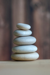 Obraz premium Harmony and balance, cairns, simple poise stones on white background, rock zen sculpture, five white pebbles, single tower