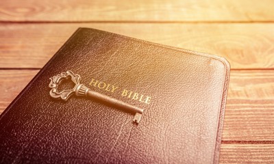 Holy Bible book on wooden background