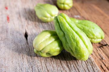 Fresh chayote fruits (Sechium edulis) on wood background