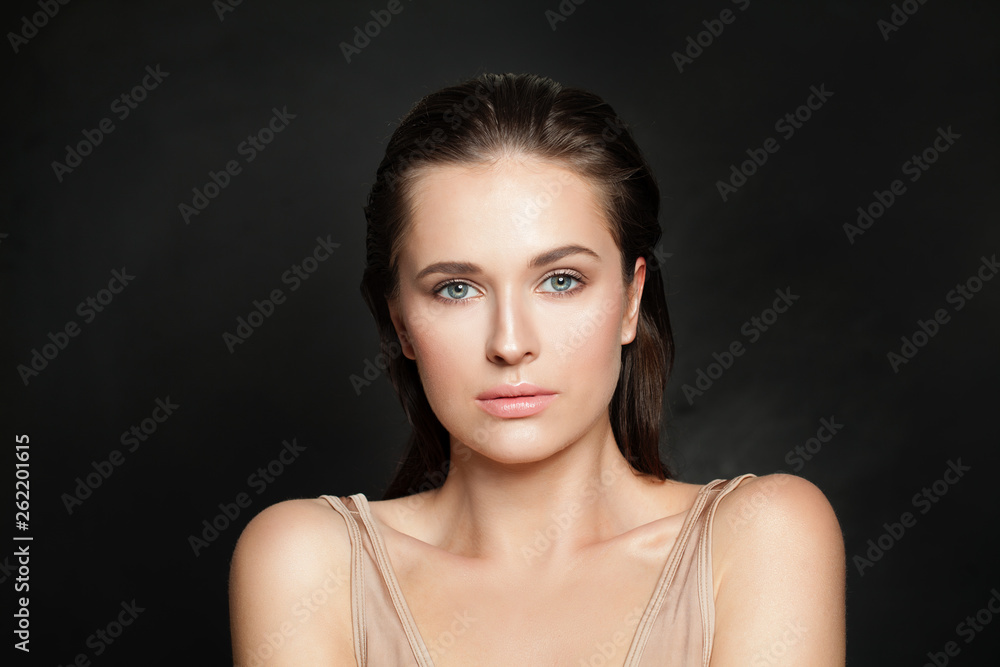 Wall mural Sensual woman model with clear healthy skin on black background