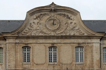Fototapeta na wymiar clock on the facade of a building in vendôme (france)
