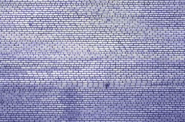 Pattern of brick wall with blur effect in blue tone.