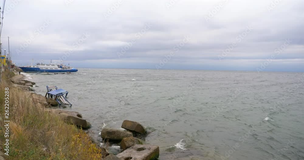 Wall mural Glum cloudy sky Baikal lake water wave landscape view in Listvyanka, Russia