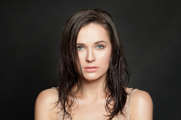 Beautiful woman after bath on black. Wet skin and hair