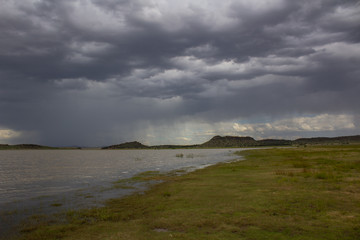 Fototapeta na wymiar African landscape - Rustfontein Dam in South Africa and the plain at the dam before storm