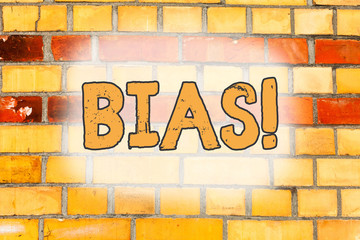 Writing note showing Bias. Business concept for inclination or prejudice for or against one demonstrating group Brick Wall art like Graffiti motivational call written on the wall