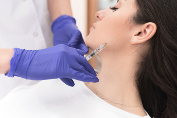 Naklejka premium Woman having corrective aesthetic procedure