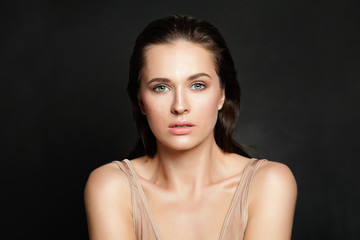 Fototapeta premium Beautiful woman with natural clear skin on black background