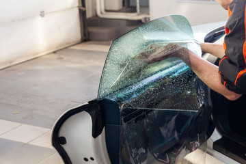 The wizard for installing additional equipment sticks a tint film on the side front glass of the...