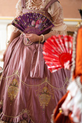 Retro style royal medieval ball - Majestic palace with gorgeous people dressed in king and queen's friends dresses with accessories such as fan and hand puch as a handbag - 2019 © dissx