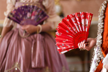 Retro style royal medieval ball - Majestic palace with gorgeous people dressed in king and queen's friends dresses with accessories such as fan and hand puch as a handbag - 2019