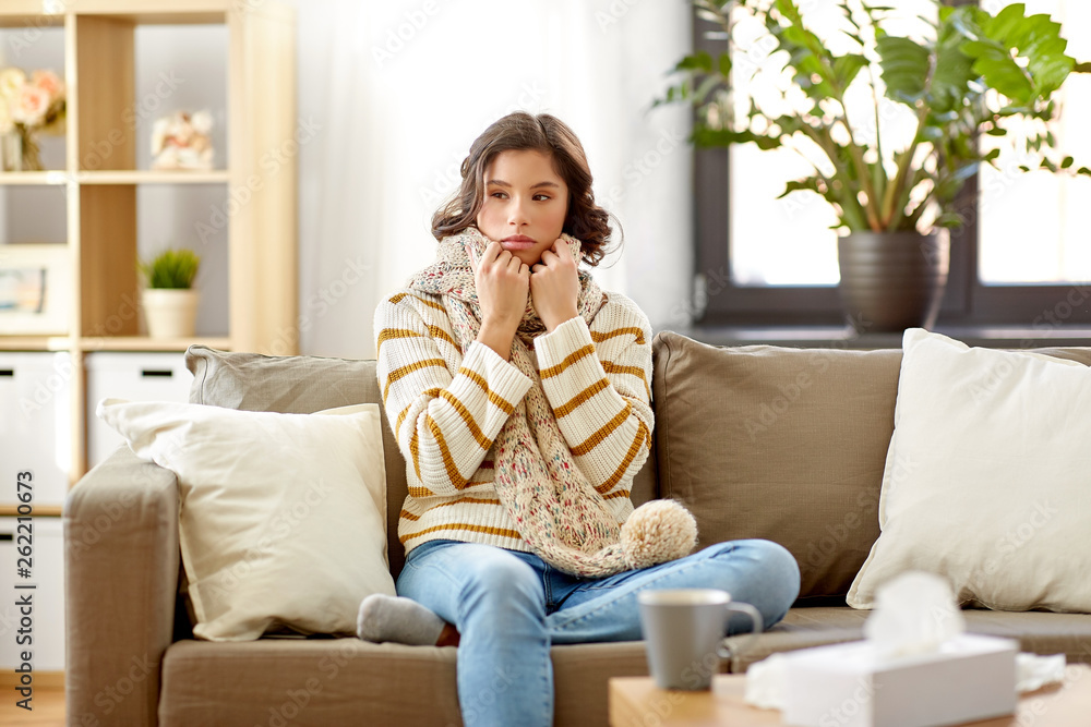 Wall mural people, health and cold concept - sad sick woman in scarf at home