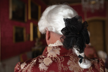 Retro style royal medieval ball - Majestic palace with gorgeous people dressed in king and queen's friends dresses with accessories such as fan and hand puch as a handbag - 2019 © dissx