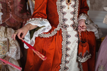 Retro style royal medieval ball - Majestic palace with gorgeous people dressed in king and queen's friends dresses with accessories such as fan and hand puch as a handbag - 2019 © dissx