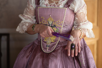 Retro style royal medieval ball - Majestic palace with gorgeous people dressed in king and queen's friends dresses with accessories such as fan and hand puch as a handbag - 2019 © dissx