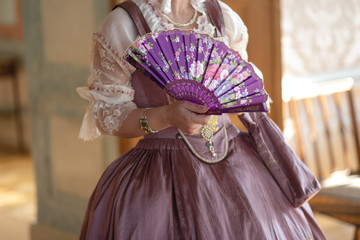 Retro style royal medieval ball - Majestic palace with gorgeous people dressed in king and queen's friends dresses with accessories such as fan and hand puch as a handbag - 2019 © dissx