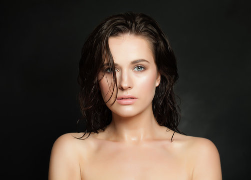 Fashion beauty portrait of perfect young woman with wet skin and hair on black