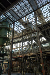 Industrial background, old abandoned factory hall with stairs and day light