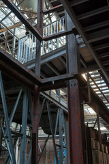 Industrial background, old abandoned factory hall with stairs and day light