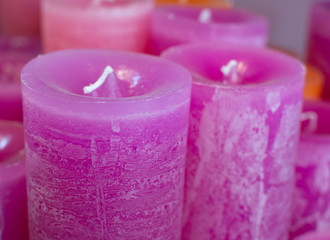 Many colorful unlit candles close up