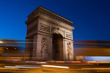 Fototapeta na wymiar The Arc de Triomphe at Night. It is one of the most famous monuments in Paris, standing at the western end of the Champs-Elyseees.