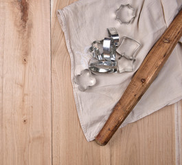 wooden rolling pin and iron bakeware on a brown wooden table