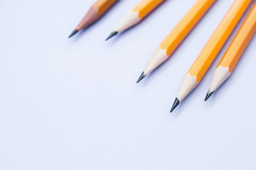 five simple pencils on a lilac background with a copy space. selective focus