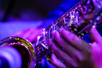 A close up picture of a artist is playing saxophone in the church.