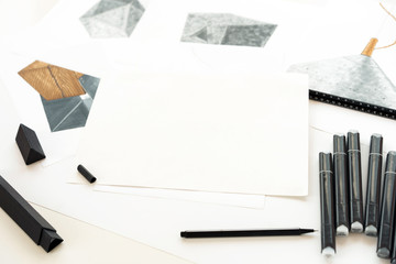 Sketch and markers are on the table. Place for text