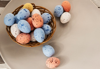 Basket with Easter eggs painted in pink and blue.