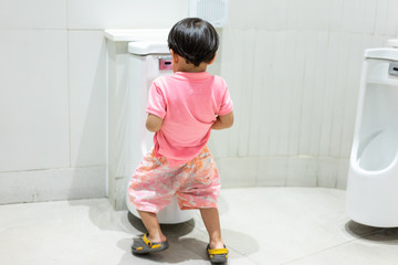 A kid is pissing himself in the bathroom.