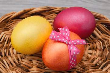 Easter eggs closeup on a wooden stand. Greeting card with Easter.