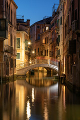 Fototapeta na wymiar View into a small canal in Venice by night
