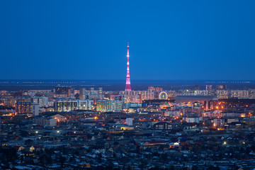 Aerial view of Yakutsk, Yakutia skyline with TV tower illuminated in bright colors and center of city in beautiful post sunset twilight during blue hour - 262221882