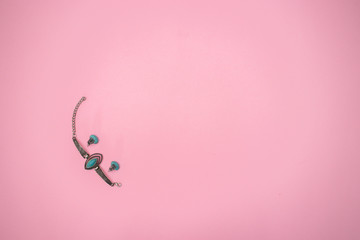 Woman's jewelry on pink background 