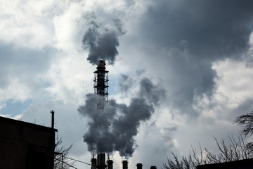 industrial smoke from chimney on blue sky background