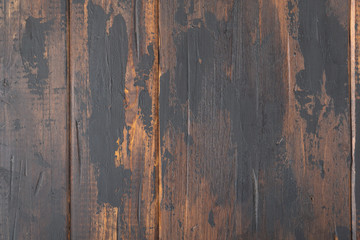 Old wooden surface background, scuffed boards with black paint stains.