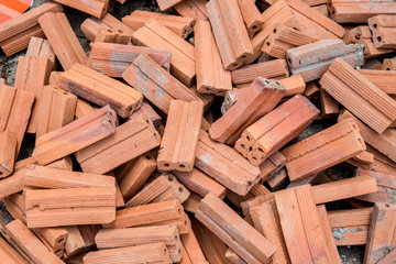 group of bricks square construction materials. bricks texture and abstract in vignette for background or copy space for text fill. Stack of disorganized brown bricks.