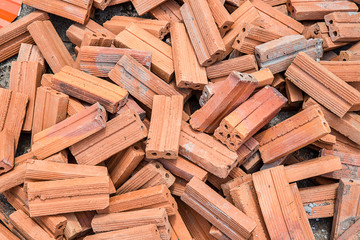 group of bricks square construction materials. bricks texture and abstract in vignette for background or copy space for text fill. Stack of disorganized brown bricks.