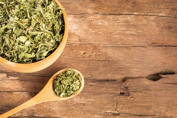 Leaves of the stevia plant - Stevia rebaudiana. Wood background