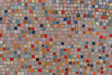 Multicoloured small square mosaic tiles evenly distributed to pattern mostly in hues of red and pink.