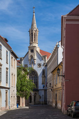 Fototapeta premium Deserted street of the ancient city with a Catholic temple