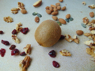 Kiwi fruit isolated on the beautiful background with dried fruits.
