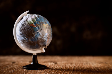 world globe wrapped in a dirty plastic