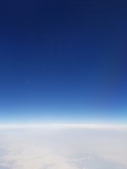 Naklejka na ściany i meble Beautiful blue sky seen from the window an airplane